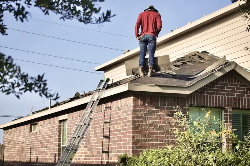 Professional roofer working on a residential roof in Wilmar